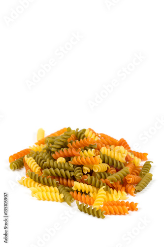 Raw colored macaroni isolated over white background
