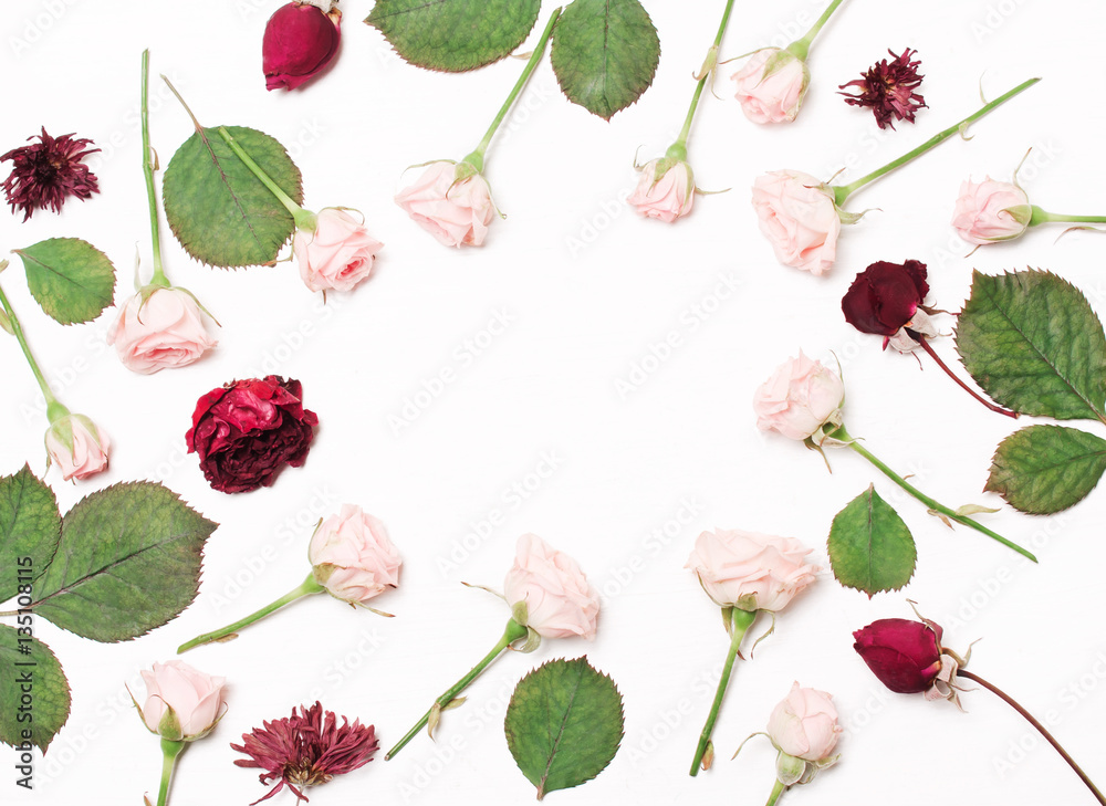 round frame of pink, red flowers on white background.