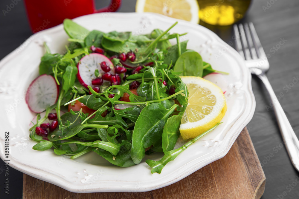 Healthy salad with baby spinach, pomegranate and rucola seasoned Healthy salad with baby spinach, pomegranate and rucola seasoned