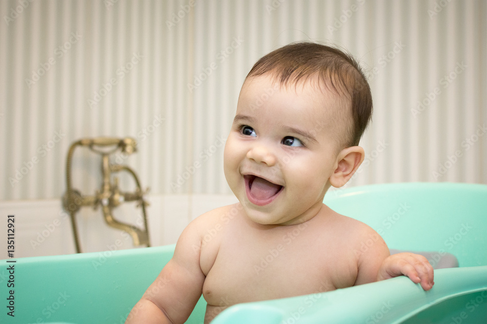 Caucasian baby boy in a small bathtub Caucasian baby boy in a small bathtub