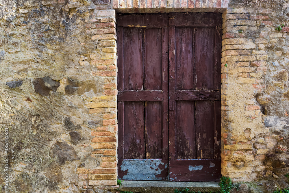 An old abandoned door in Montalcino, Tuscany. An old abandoned door in Montalcino, Tuscany.