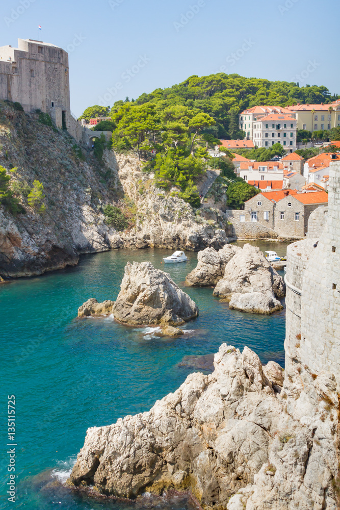 Walled fortress of Dubrovnik with blue waters of Adriatic