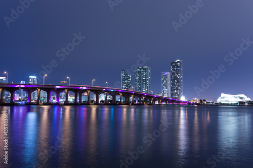 View on Miami Downtown and MacArthur Causeway at night time with a view on a bay, Sunset. USA