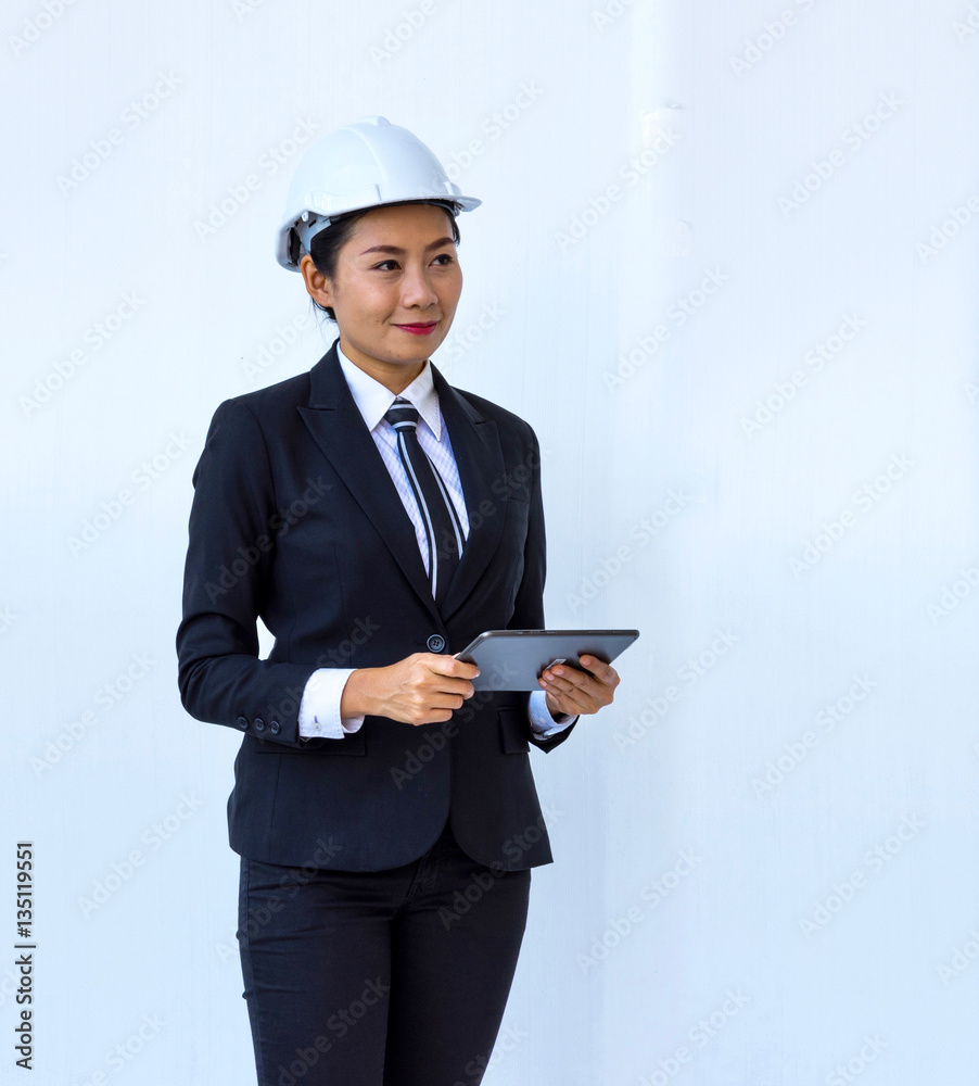 Woman engineer looked to the side and use the tablet Woman engineer looked to the side and use the tablet
