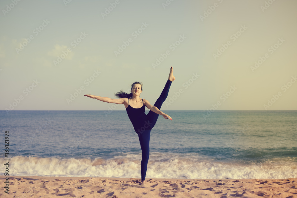 Woman is doing fitness, sunny blue sky sand beach outdoors background