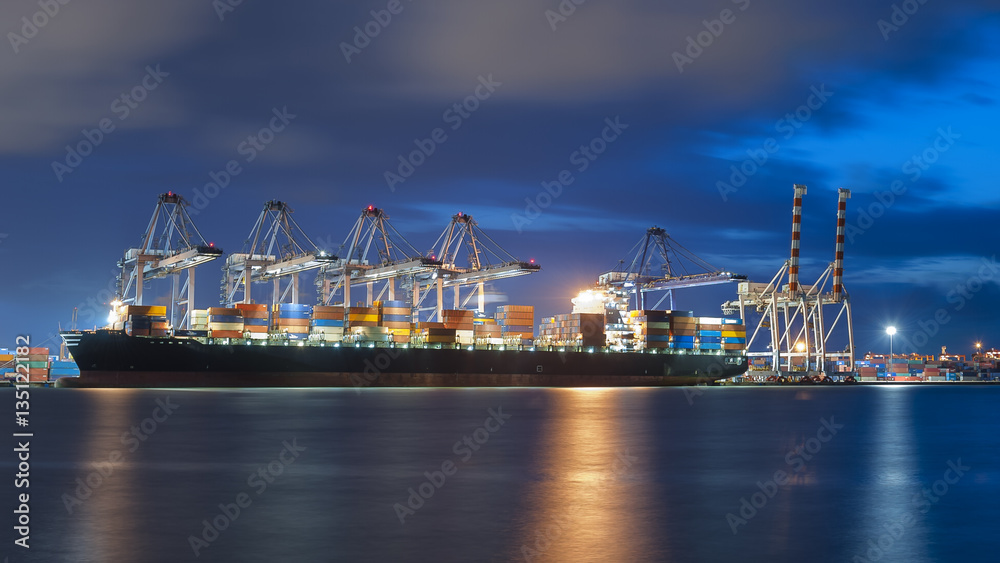 Container Cargo freight ship with working crane bridge in shipyard at dusk for Logistic Import Export background. Containers loading by big crane during twilight, Shipping Trade Port in Thailand