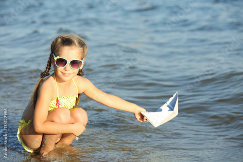 Cute girl playing with pape...