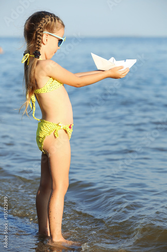 Cute girl playing with pape...