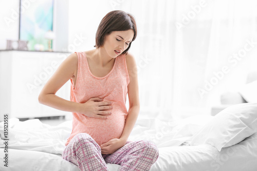 Young pregnant woman suffer...