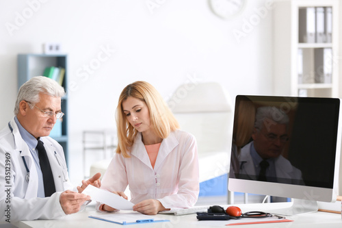 Doctors working at table wi...
