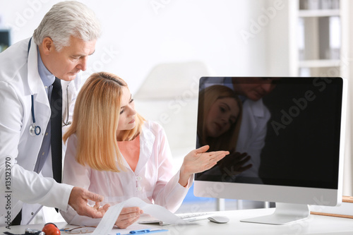 Doctors working at table wi...