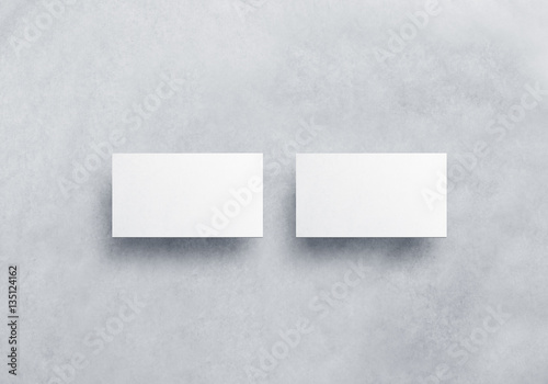Blank white business card mockups isolated on grey textured background. Front and back side namecard design mock up presentation. Empty horizontal visiting paper sheets template with shadows.