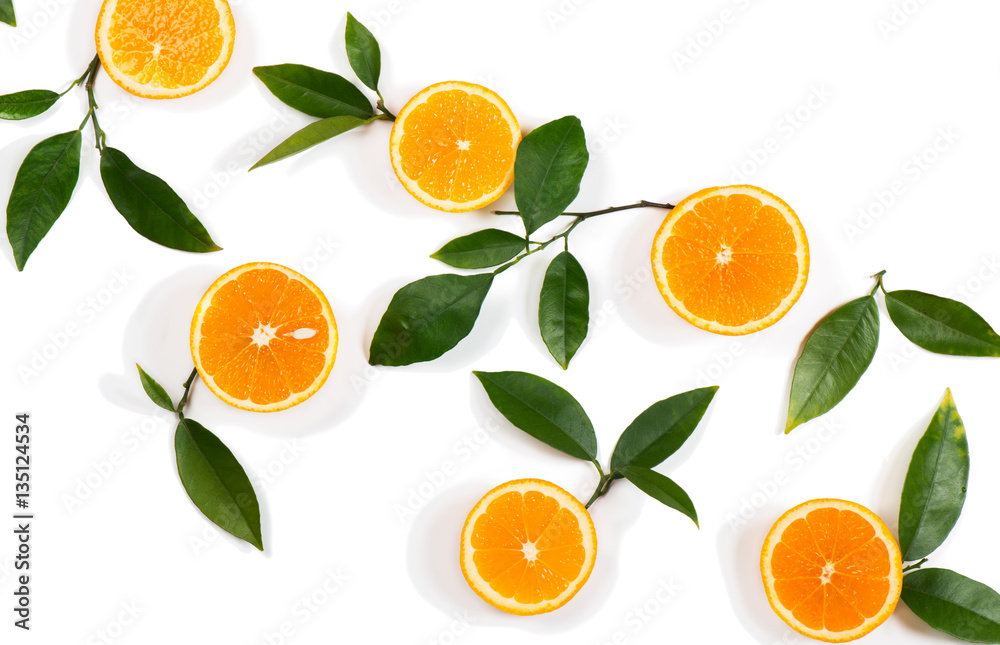 Slices of orange fruits and green leaves. Slices of orange fruits and green leaves.
