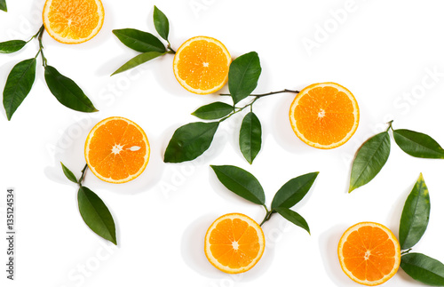 Slices of orange fruits and green leaves.