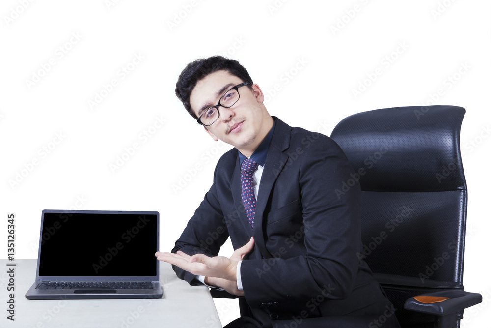 Businessman displaying a laptop on the table Businessman displaying a laptop on the table