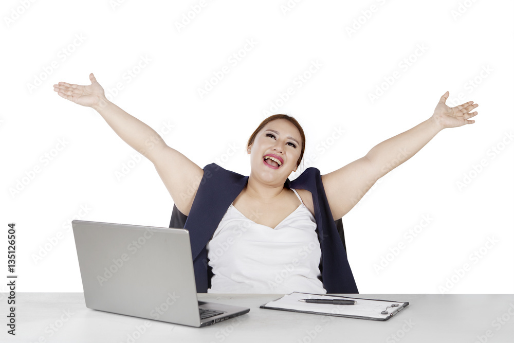 Businesswoman raising hands in studio Businesswoman raising hands in studio