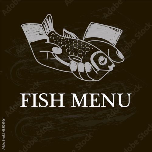 Fish in hands. Fish menu painted on a chalk board photo