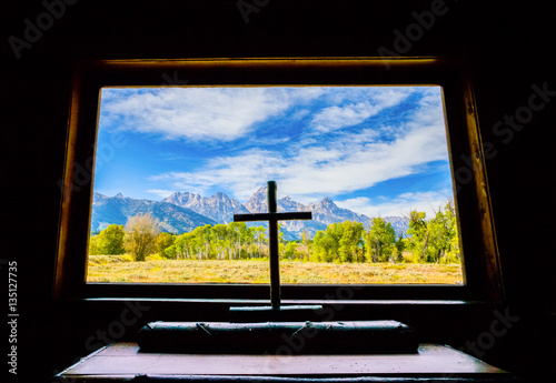 Grand Teton Mountains view through the window of a church. Grand Tetons National Park, Jackson Hole, Wyoming, USA.