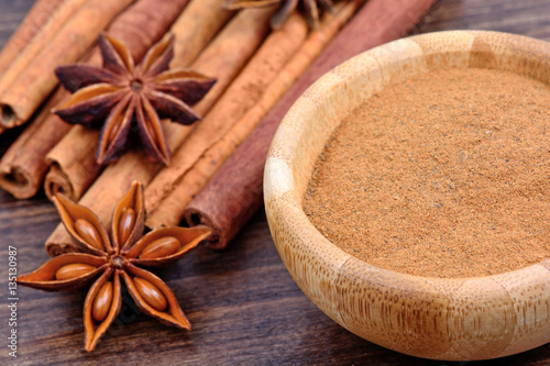 Cinnamon with anise star on wooden background
