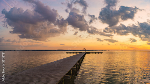 Fototapeta Naklejka Na Ścianę i Meble -  wooden pier overlooking the lake, the beautiful evening sky
