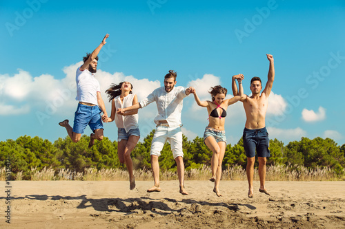 Group of friends together on the beach having fun.