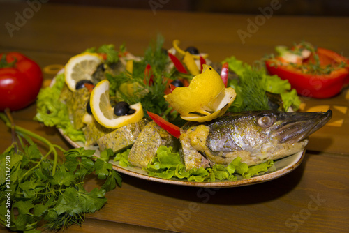 Stuffed pike with vegetables and herbs.