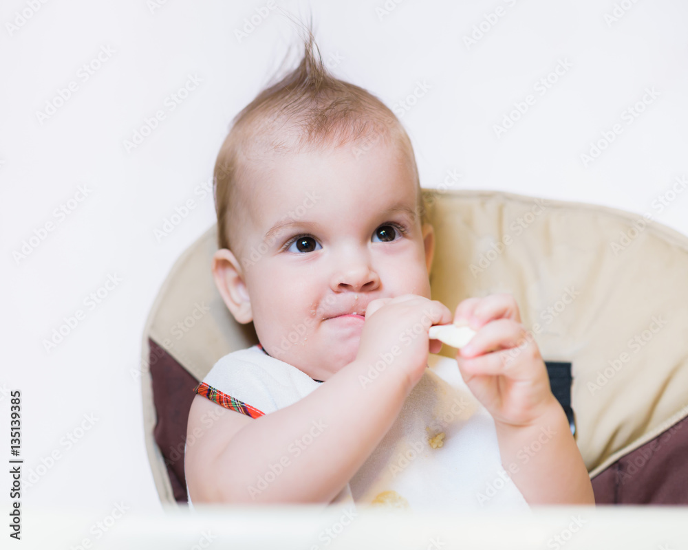 baby holding a spoon in his mouth baby holding a spoon in his mouth