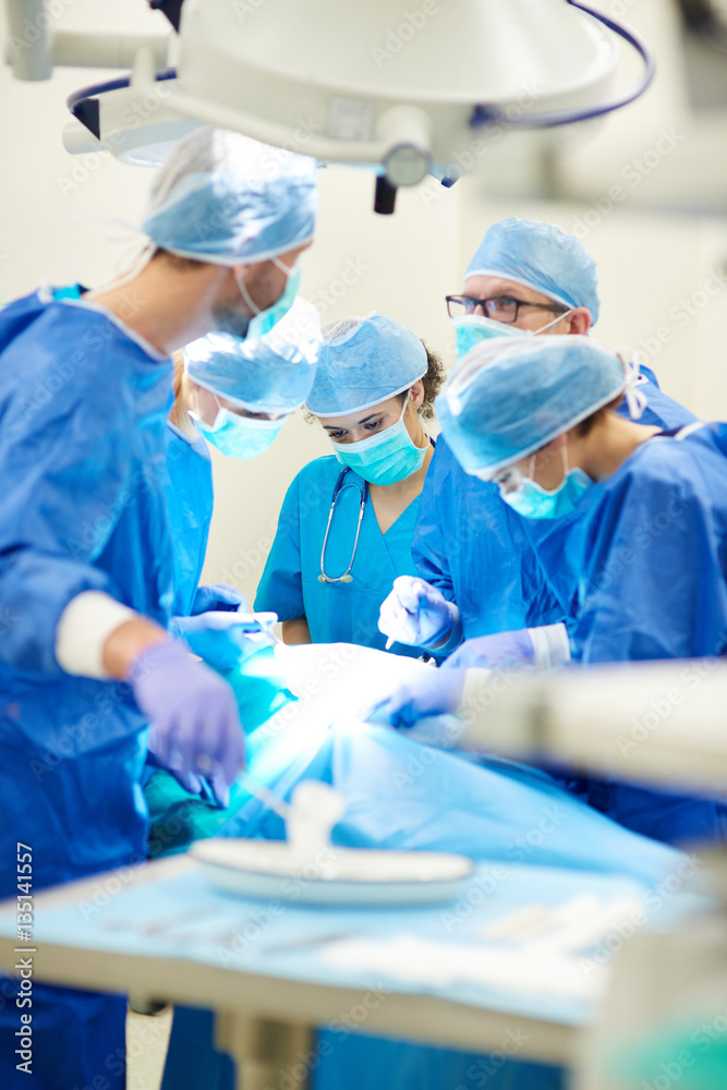 Busy doctors over the operating table Busy doctors over the operating table