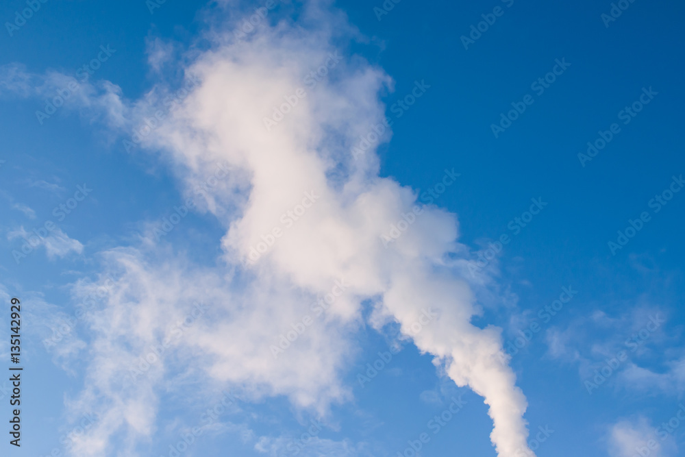 The texture of the smoke white against the blue daytime sky