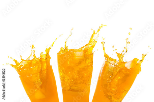 Orange juice splashing out of glass., Isolated white background with copy space.