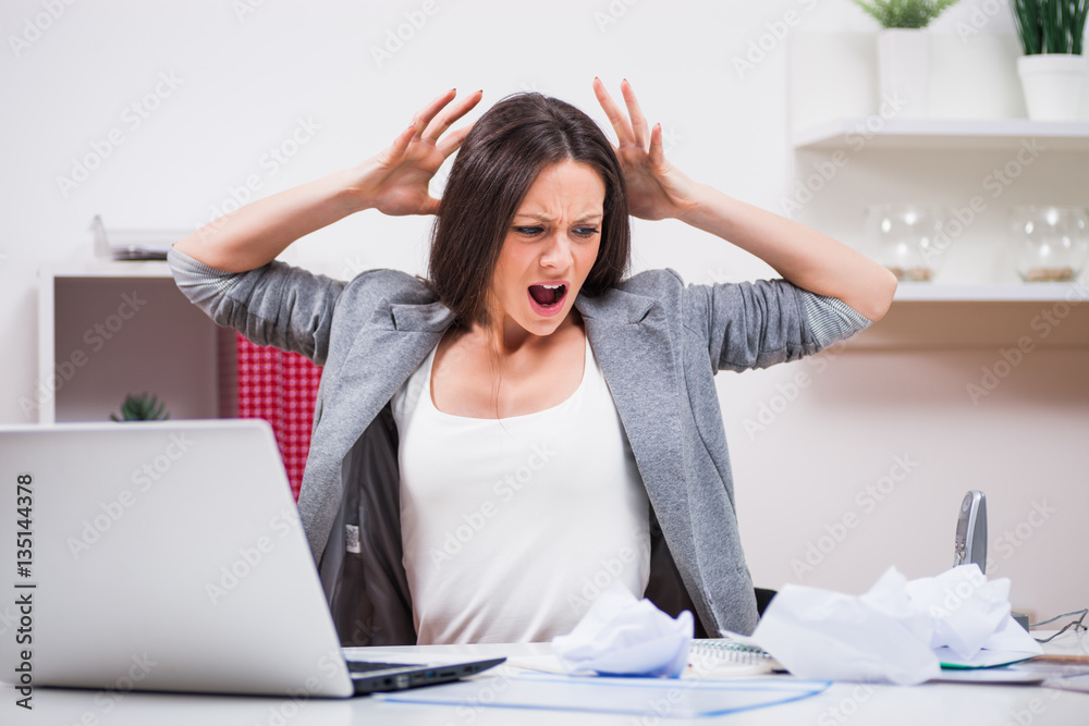 Young businesswoman is angry because she is tired of work. Young businesswoman is angry because she is tired of work.
