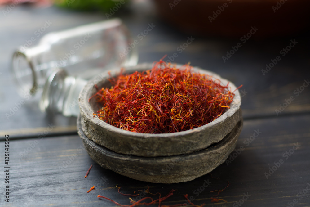 Raw Organic Red Saffron Spice in a clay bowl Raw Organic Red Saffron Spice in a clay bowl