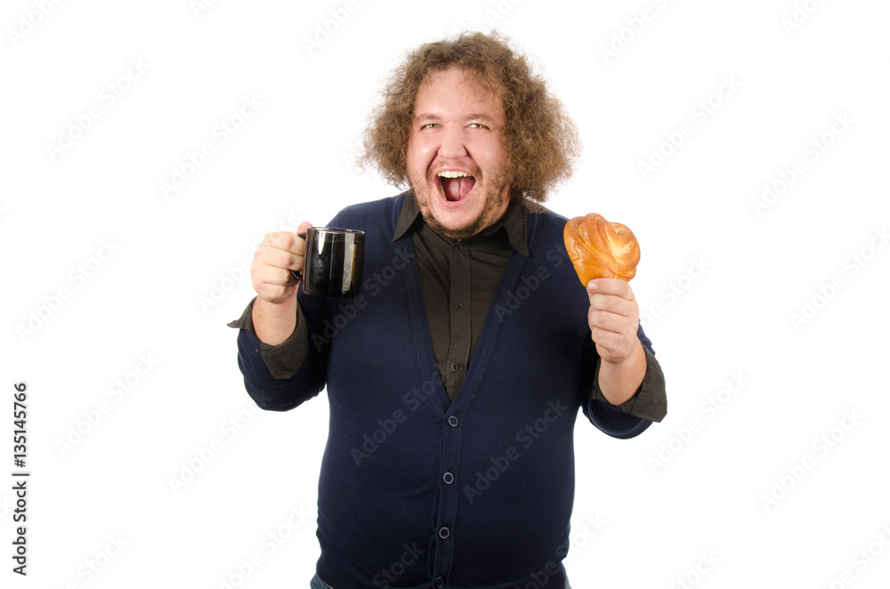 Morning coffee, lunch. Man with a mug and a bun. Morning coffee, lunch. Man with a mug and a bun.