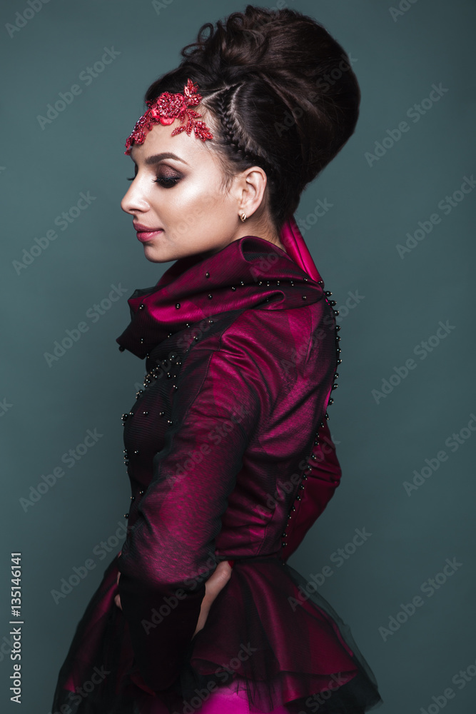 Beautiful girl in evening dress with avant-garde hairstyles. Beauty the face. Photos shot in the studio. Beautiful girl in evening dress with avant-garde hairstyles. Beauty the face. Photos shot in the studio.