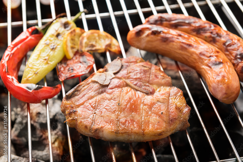 Pork chop steak and vegetable with sausage on a flaming BBQ gril Pork chop steak and vegetable with sausage on a flaming BBQ gril