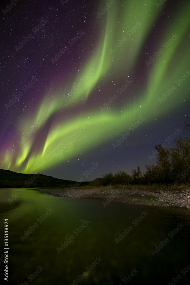 Aurora Borealis over the river. River Paypudyna. Polar Urals. Russia.