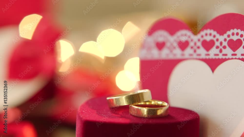 Gold wedding rings with bokeh lights