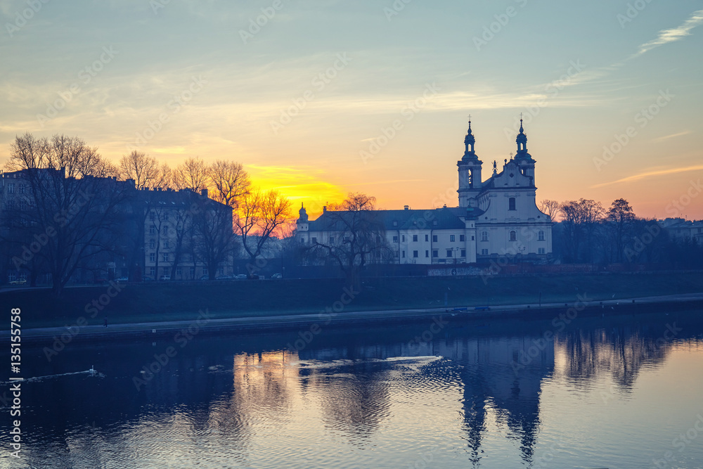 Church on the Skalka at sunrise in old town in Krakow with reflection in the river, Poland