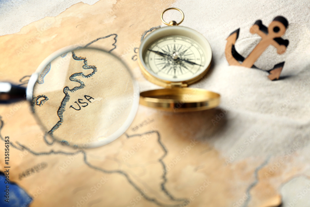 Obraz premium View at old map through magnifier. Columbus Day concept