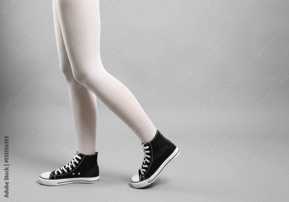 Woman in white tights and sneakers on gray background Stock Photo | Adobe  Stock