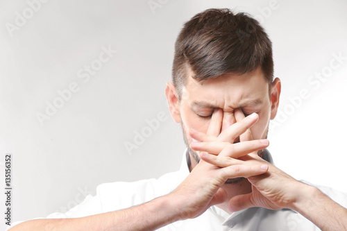 Vászonkép Young man with headache on white background