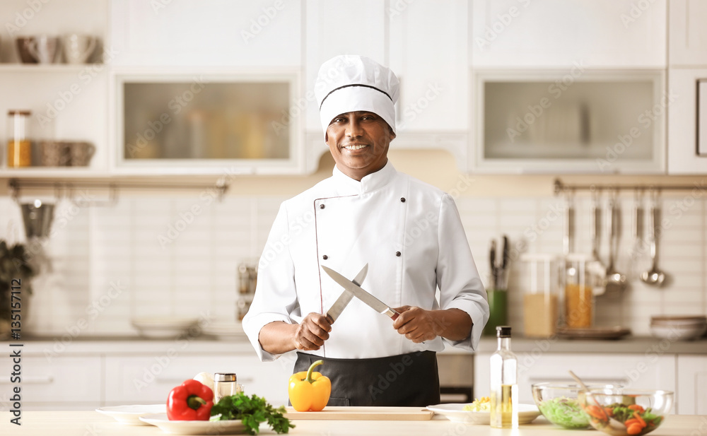 Mature Indian chef cooking in kitchen Mature Indian chef cooking in kitchen