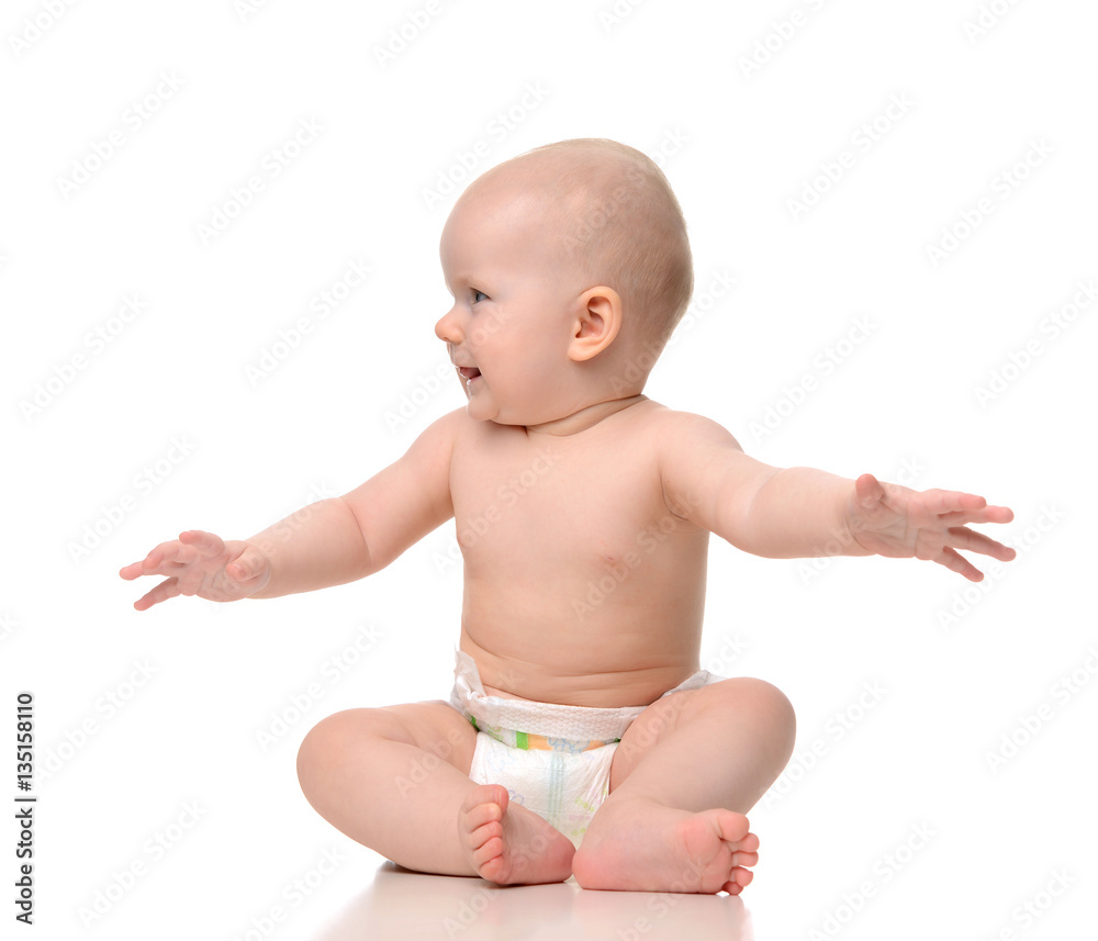 Infant child baby girl toddler sitting naked in diaper looking a Infant child baby girl toddler sitting naked in diaper looking a