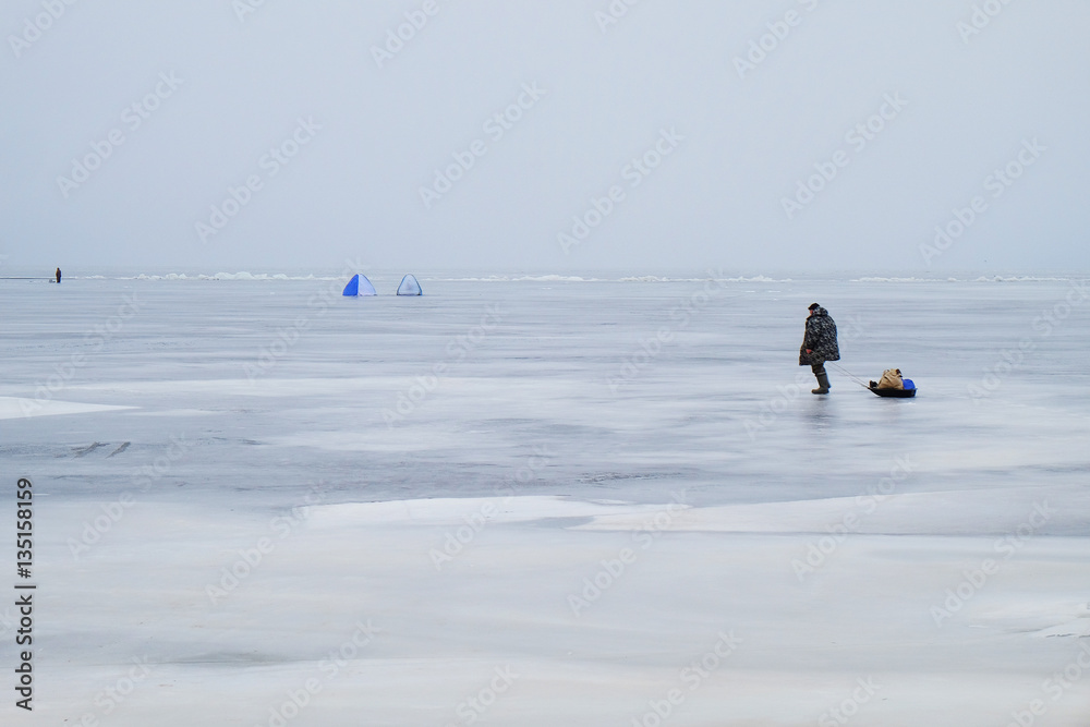 fisherman goes ice fishing