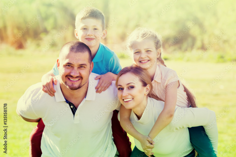 Fototapeta premium Joyful parents with children outdoor.
