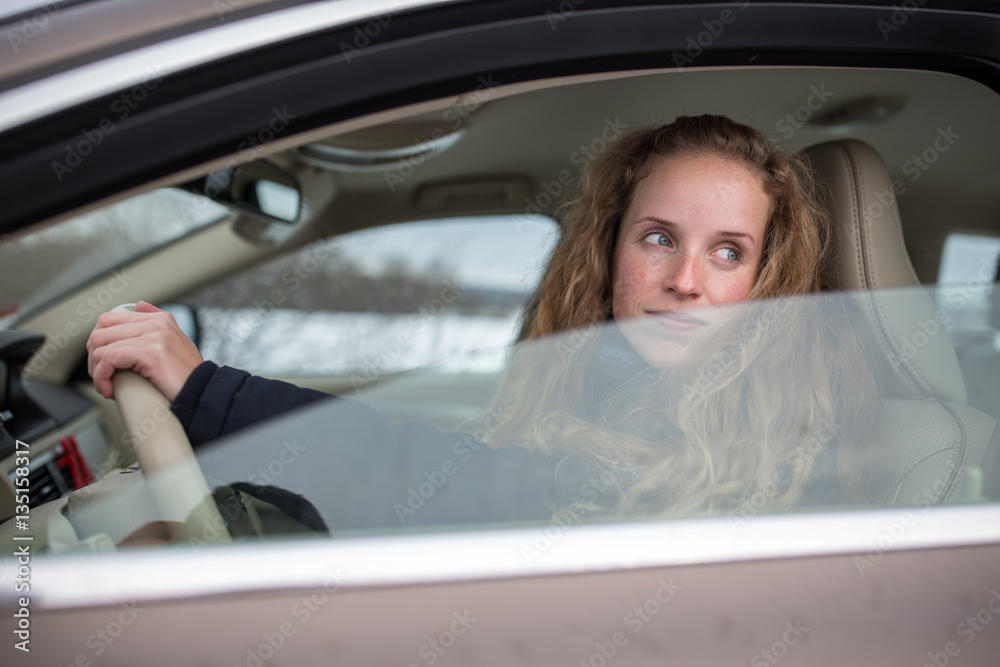 Pretty young woman driving her new car Pretty young woman driving her new car