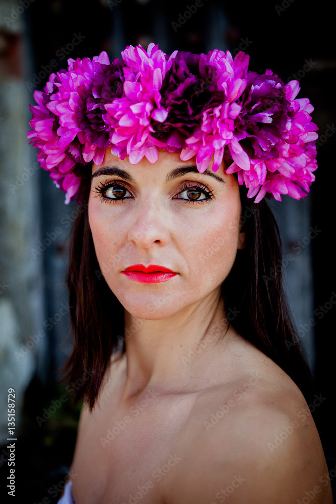 Naklejka premium Beautiful Young Woman with Pink Flowers in the Hair