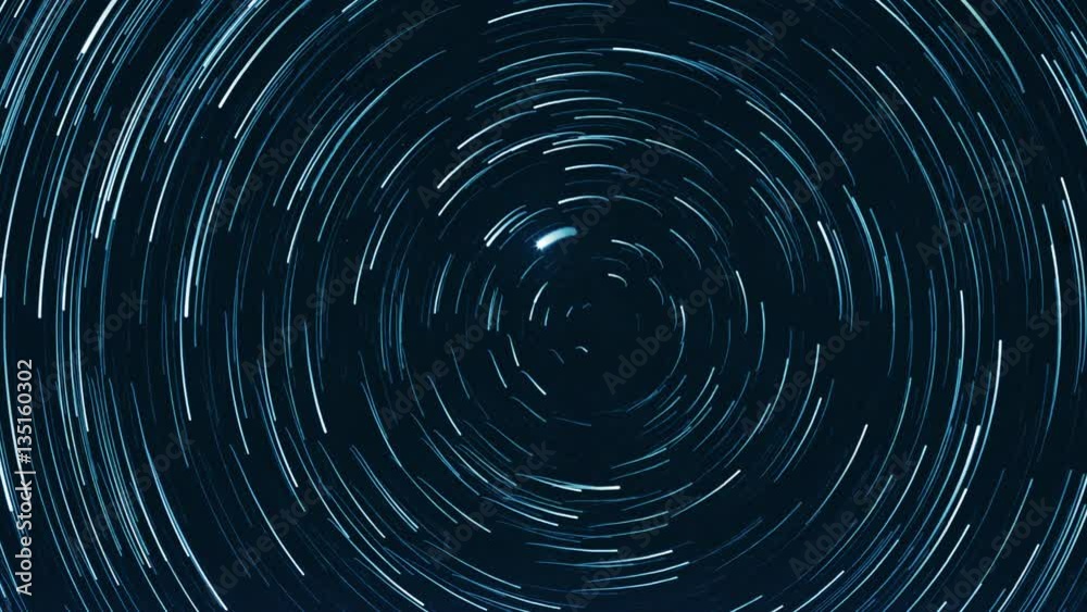 Starry sky time lapse with the star trails like comets. North Pole Star (Alpha Ursae Minoris) is in the center.