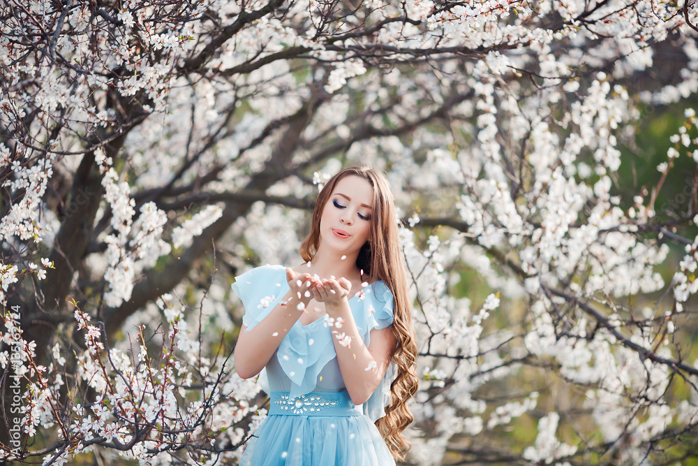 Happy beautiful young woman in spring blossom park. Happy beautiful young woman in spring blossom park.