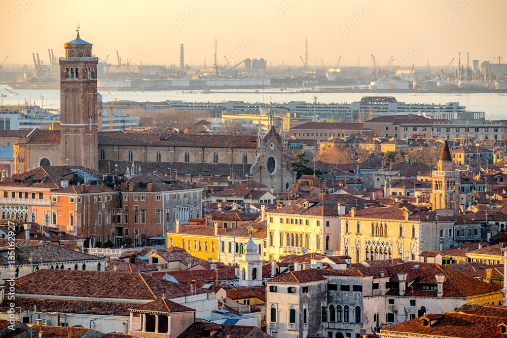 Fototapeta Panoramic aerial cityscape of Venice,with rooftops, the sea at sunset, Veneto, Italy.